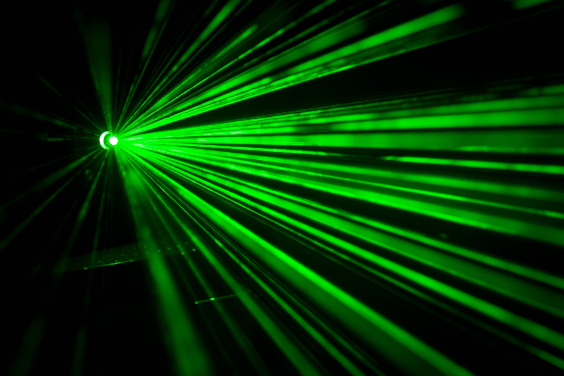 Image of several green lazer beams shining towards the camera. LED therapy available at the Karlfeldt Center of Meridian, Idaho.